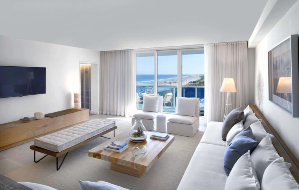 Hotel suite living room with balcony overlooking the ocean