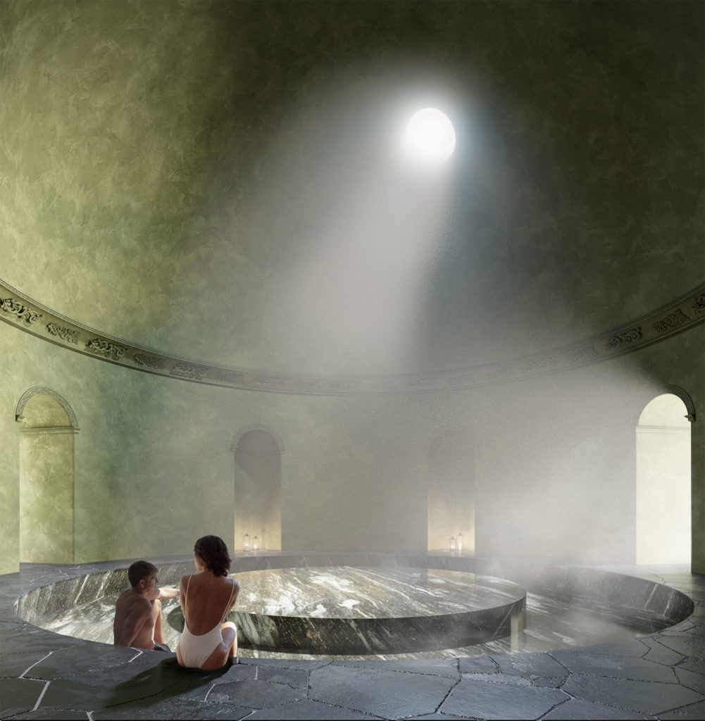 two people inside a large stone bathhouse