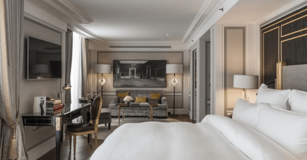Hotel de Crillon suite with two televisions and silver modern furnishings.
