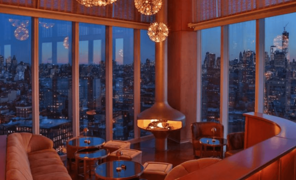 The Standard hotel room with floor to ceiling windows looking out on NYC