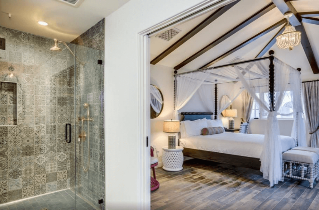 King suite with a Spanish-tiled bathroom and canopied bed.